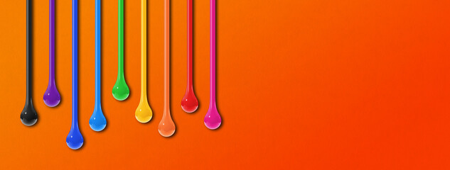 Colorful ink drops on orange background. Horizontal banner