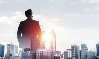 Concept of business success and control with confident boss against cityscape background