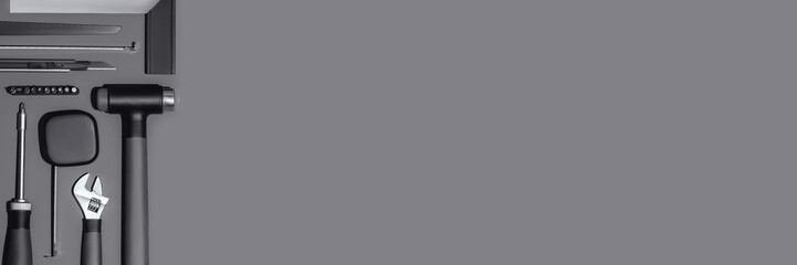 Flat lay composition with set of home repair tools on dark grey background. Top view pattern with copy space. Web banner.