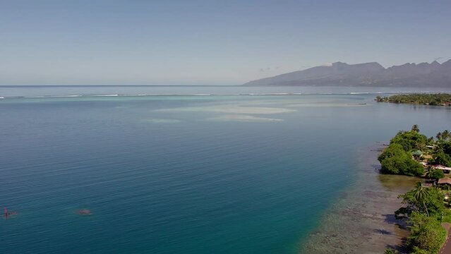 Aerial Orbit Shot of a Beachside Road in Tahiti and the Coral Reefs of Tahiti Iti