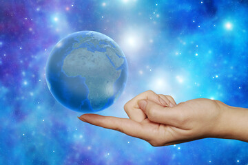 holding a planet Earth in balance on a finger