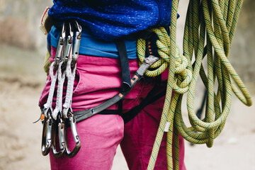 Young female rock climber prepearing for climbing the route