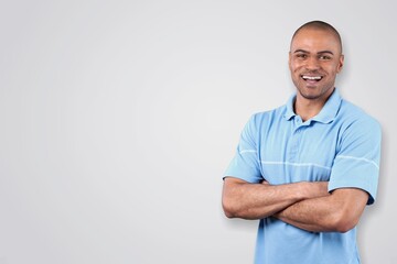 A young happy man standing and posing on background