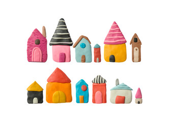 Fototapeta na wymiar Multicolored plasticine buildings. Set of cute handmade houses. Modelling clay.