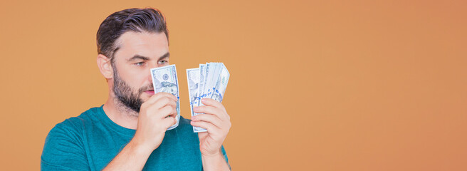 Successful man counting money. Handsome middle age man holding bunch of 100 dollar banknotes. Guy...