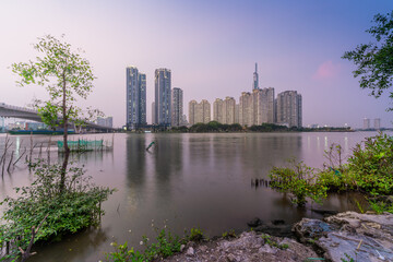 Obraz premium view of Landmark 81 skyscraper and Saigon river in center Saigon, Vietnam and Thu Thiem bridge. Business and travel concept.