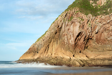 Fototapeta na wymiar Ballota beach in llanes with its famous rock formation at sunset, Asturias, Spain
