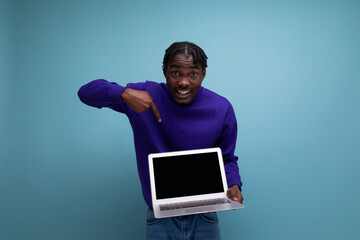 IT specialist african young brunette man with dreadlocks with laptop