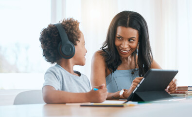 Elearning, happy and a mother and child with a tablet for education, studying and online class. Smile, teaching and a mom helping a boy kid with homework with technology during homeschooling
