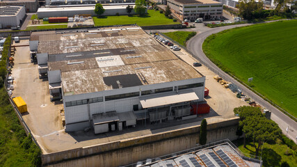 Aerial view of a large shed that is used as a warehouse for loading and unloading parcels. Many...