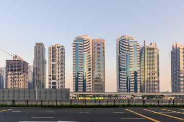 Fototapeta na wymiar Central street Sheikh Zayed Rd in the rays of the setting sun in Dubai city, United Arab Emirates