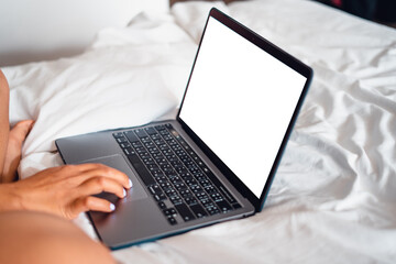 Laptop on empty bed,Caucasian woman laying on bed using laptop