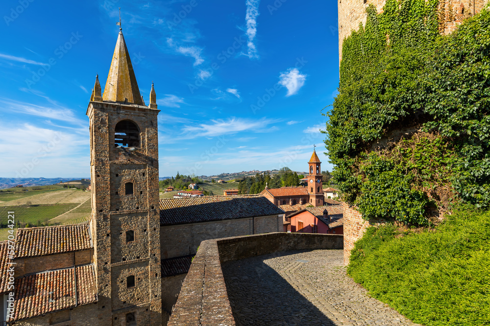 Wall mural Rooftops and medieval belfry under blue sky in Italy.