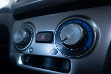 selectively focus on the air conditioner (AC) control panel on the car dashboard. soft focus. under exposure