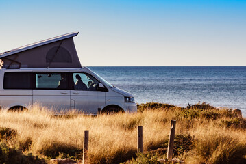 Camper van with roof top tent camp on beach