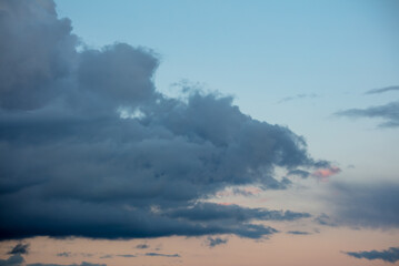 Rain clouds at sunset as background