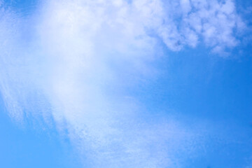 Light bright blue peaceful sky with white cirrus clouds