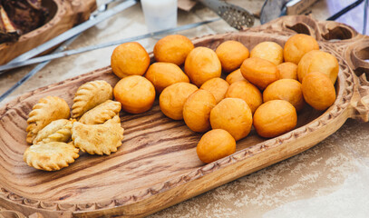 Fried doughnuts on a wooden tray