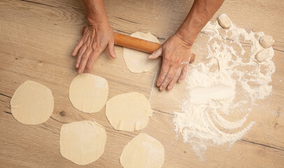 Rolling out the dough with your hands.