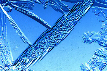 Drawings of ice on blue glass.