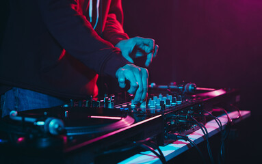 Club DJ mixing music set. Professional disc jokey playing hip hop on a party