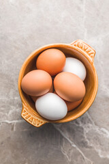 Whole chicken eggs in bowl. Top view.