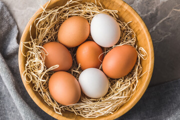 Whole chicken eggs in basket. Top view.