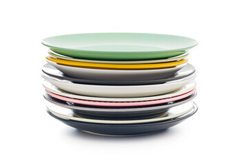 Stacks of colorful porcelain plates isolated on white background.