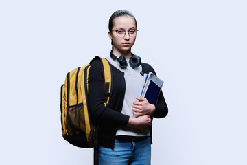 Portrait of teen girl high school student on white studio background