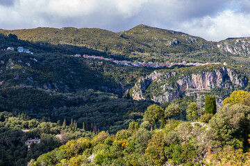 A beautiful landscape of the island of Corfu in the Ionian Sea in Greece. Mountains with plenty of green vegetation. Thick clouds over the island. 