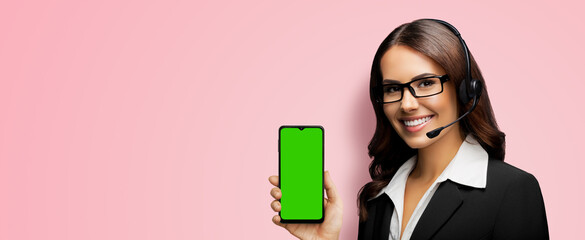 Customer support phone operator in glasses, headset hold show smartphone cell phone mobile green...