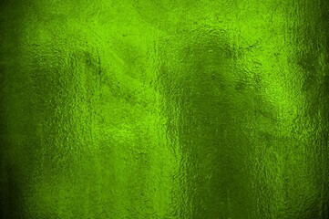 Glitzernde grüne Folie als Hintergrund Textur
