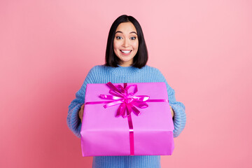 Portrait of pretty positive person toothy smile hands hold desirable giftbox isolated on pink color...