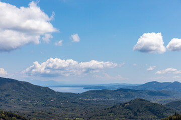 Fototapeta premium A beautiful landscape of the coast of the island of Corfu in the Ionian Sea of the Mediterranean in Greece. Pure blue clear water washes over the shores of the Greek island.