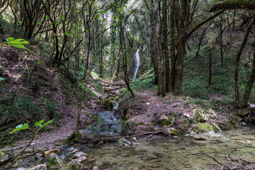 A beautiful waterfall in the mountains on the island of Corfu in Greece. A tourist spot for nature lovers. 