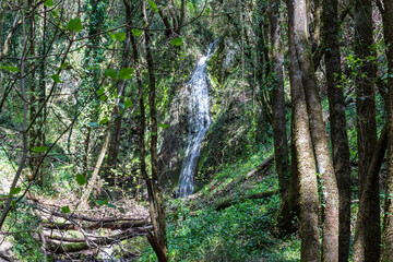 A beautiful waterfall in the mountains on the island of Corfu in Greece. A tourist spot for nature lovers. 