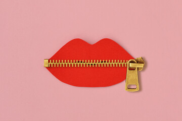 Paper lips cut-out with zipper on pink background - Concept of violence against women and communication issues