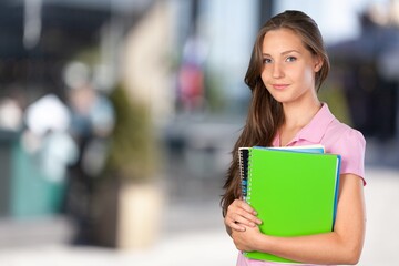Pretty young woman university student with books
