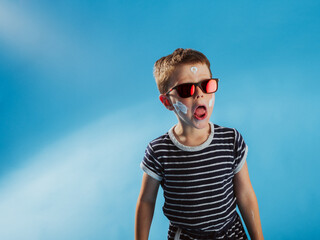 Funny school kid having fun in a studio