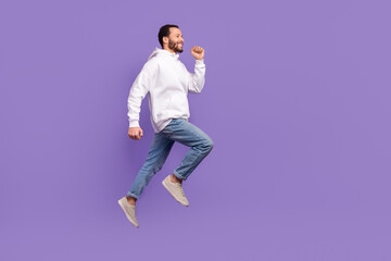 Fototapeta na wymiar Full length body image photo of young hispanic man wear hoodie with denim walking empty space adventures isolated on purple background