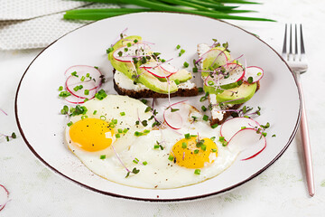 Fried eggs and sandwiches with avocado and radish  for healthy breakfast.