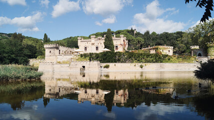 Fototapeta na wymiar Lake with ducks and castle reflected in the water. Jal pi castle in Arenys de munt, 20th century, located in the Maresme region. Tourist sites near Barcelona. 