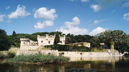 Fototapeta na wymiar Lake with castle in the background in the nature. Jal pi castle in Arenys de munt, 20th century, located in the Maresme region. Tourist sites near Barcelona.