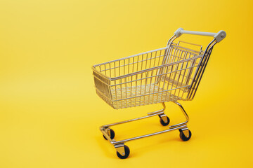 Striking Shopping: Cart Set Against a yellow Background. Generative AI