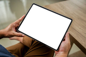 A businessman holds a mockup. iPad digital tablet with blank screen Mockup replaces your design...