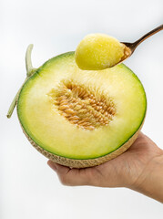 Golden spoon with Crown Musk Melon on white background, Shizuoka Crown Melon Yama Grade on isolate on white background.