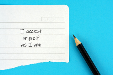 Torn paper with inspirational quotes text - I accept myself as I am