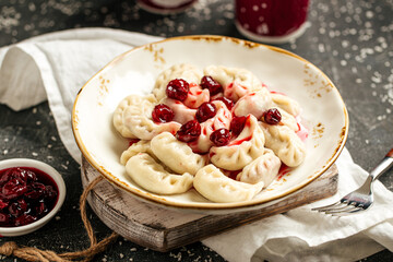 Portion of russian dumplings vareniki with cherry filling