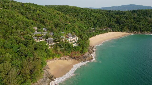 Phuket, Thailand: Dramatic drone footage of the Nai Thon and Banana beaches in the Phuket tropical island lined with luxury real estate and resort in the Andaman sea in Thailand. 