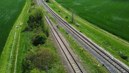 train railways running through the green wheat field, drone photography